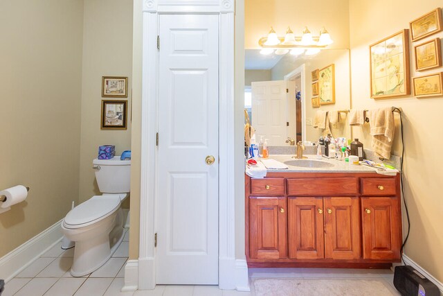 bathroom with vanity, toilet, and tile patterned floors