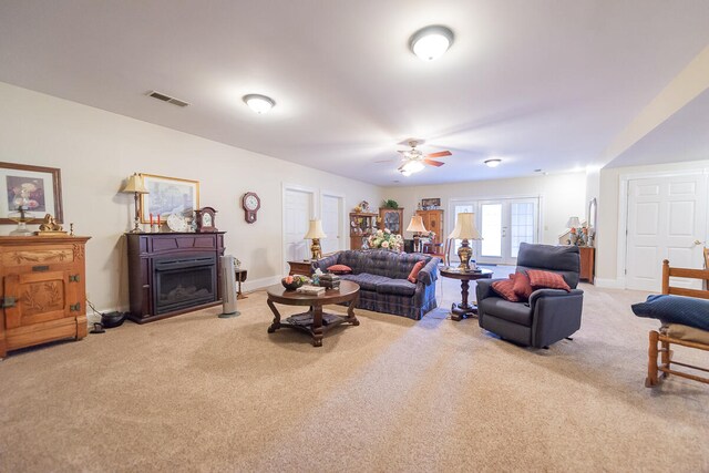 living room with french doors, light carpet, and ceiling fan