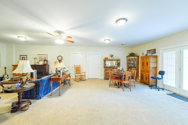 carpeted living room featuring ceiling fan