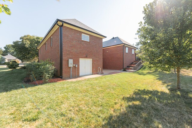 rear view of property with a yard