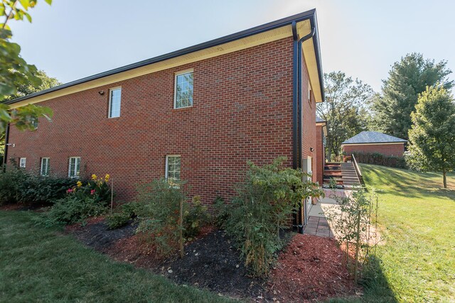 view of property exterior with a yard