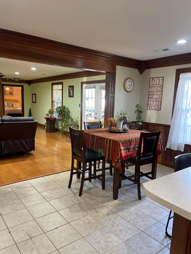 tiled dining space featuring ornamental molding