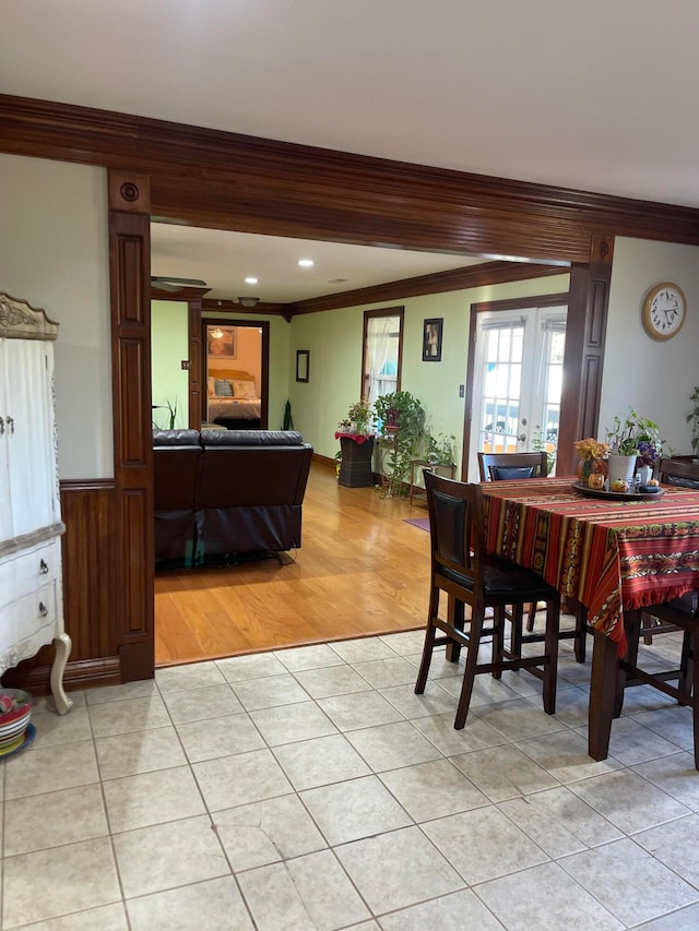 dining area featuring ornamental molding and light wood-type flooring