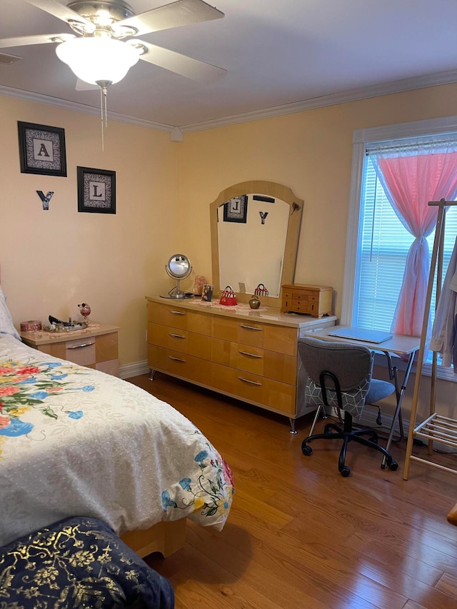 bedroom featuring ornamental molding, dark hardwood / wood-style floors, and ceiling fan