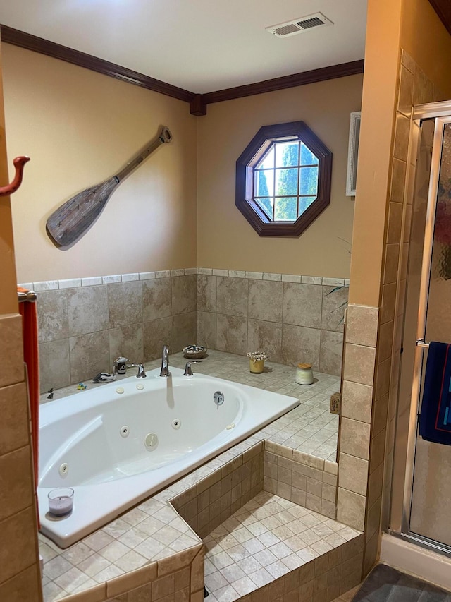 bathroom featuring ornamental molding and separate shower and tub