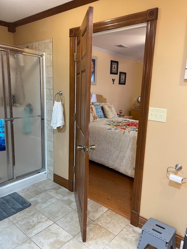 bathroom with crown molding, a shower with shower door, and hardwood / wood-style floors