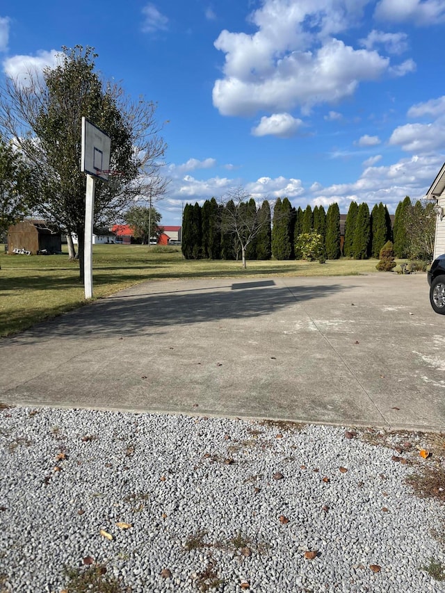 view of parking / parking lot featuring a lawn