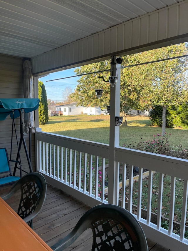 deck featuring a lawn and a porch