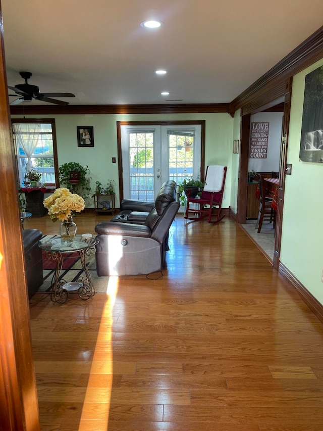 living room with crown molding, french doors, hardwood / wood-style flooring, and ceiling fan