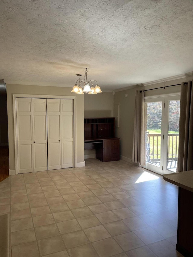 unfurnished living room featuring a notable chandelier, a textured ceiling, and light tile patterned flooring