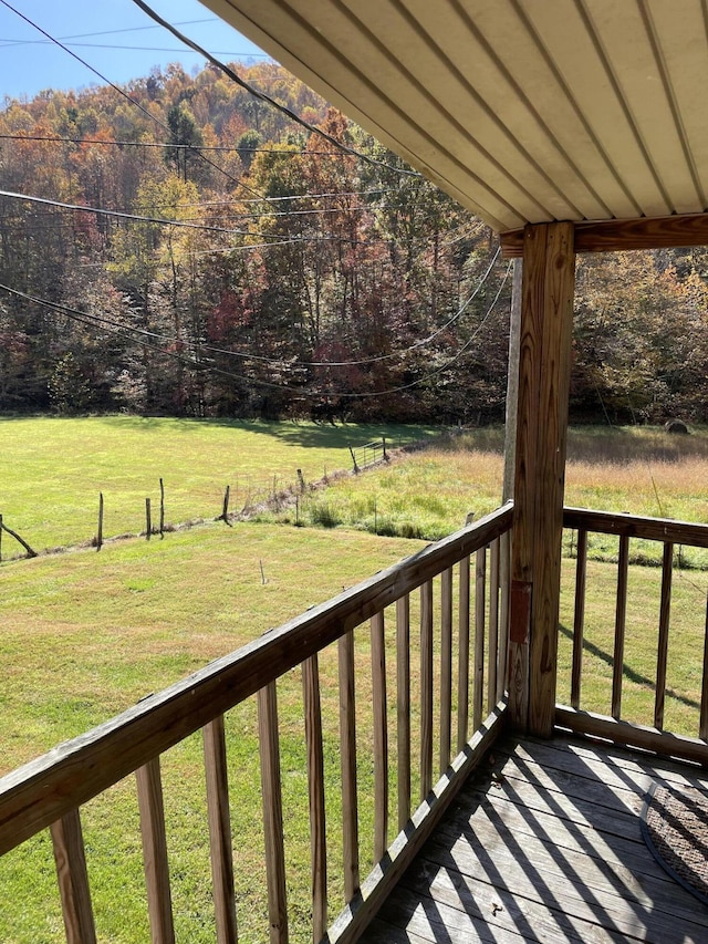 wooden deck featuring a lawn