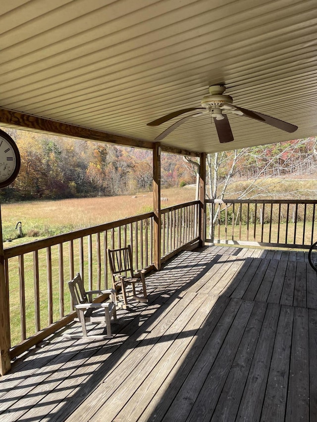 wooden deck featuring ceiling fan