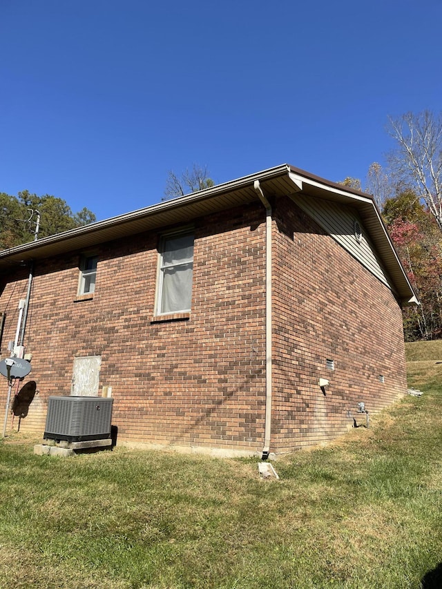 view of home's exterior with central AC and a lawn