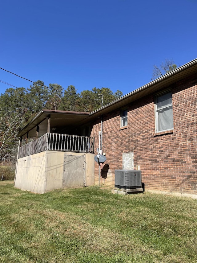 view of home's exterior featuring a yard and central AC unit