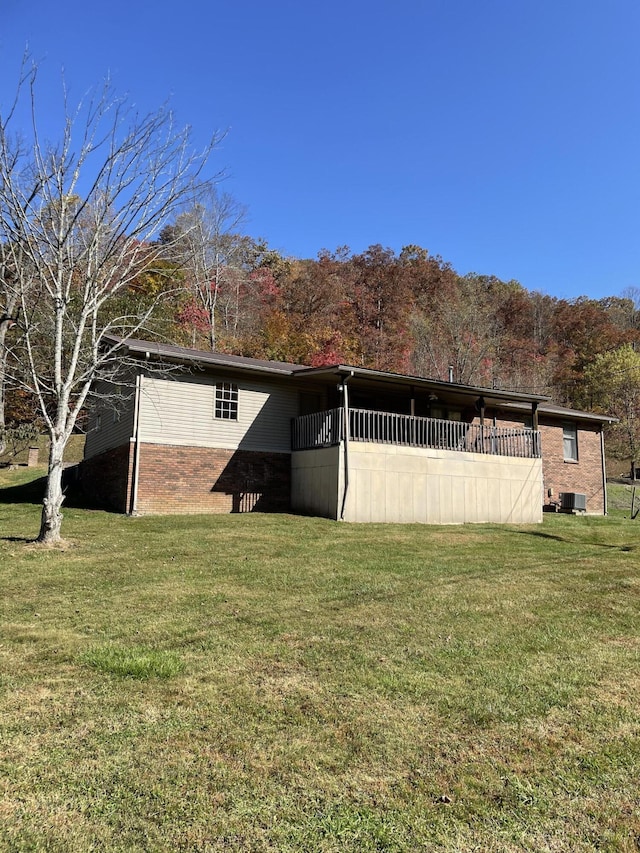 exterior space featuring central AC and a lawn