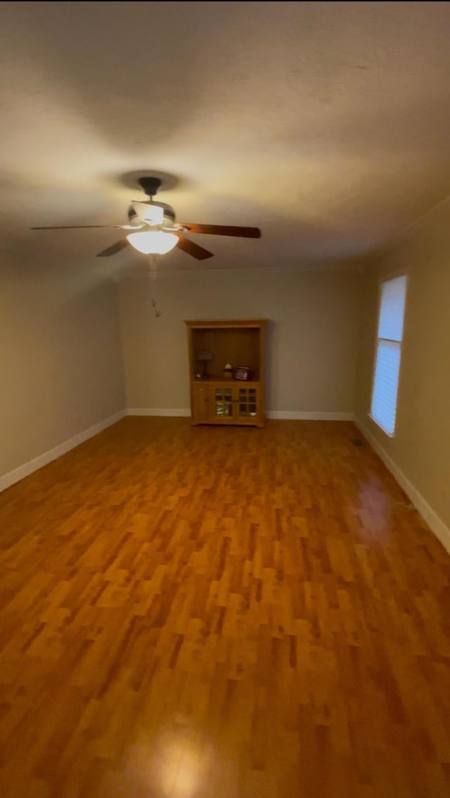 spare room featuring ceiling fan and wood-type flooring