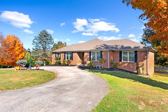 ranch-style home featuring a front yard