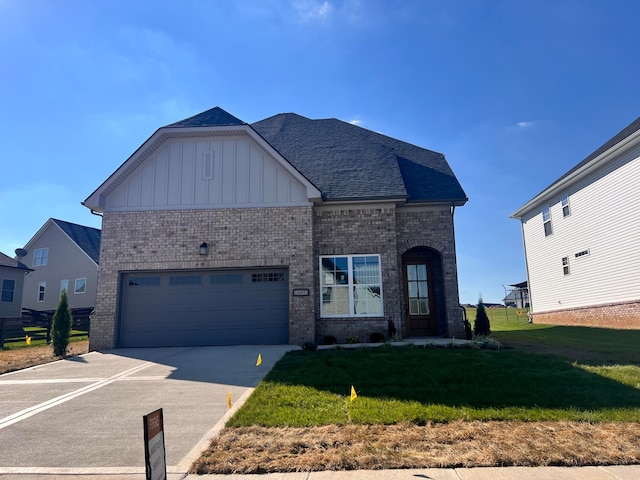 view of front of house with a front yard and a garage