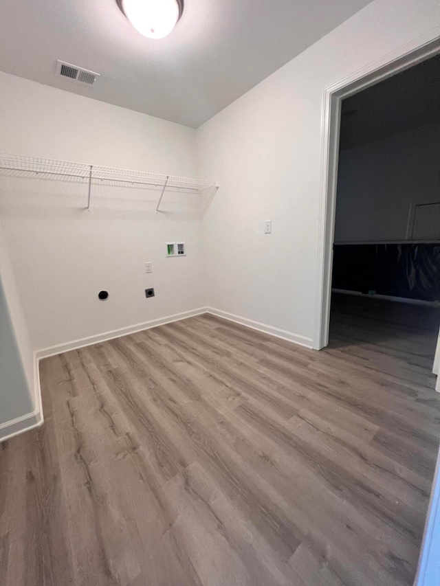 clothes washing area featuring hardwood / wood-style floors and hookup for a washing machine