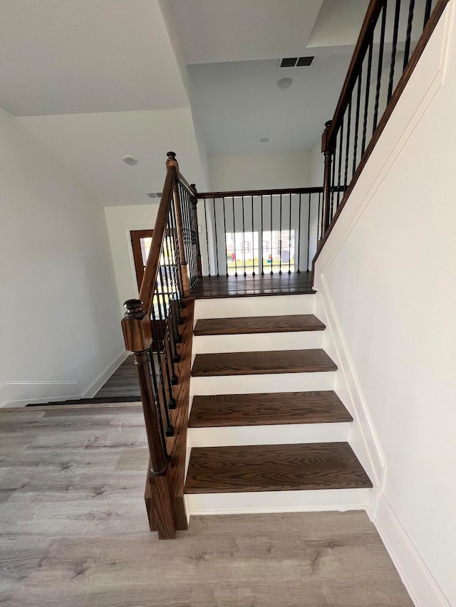 stairway featuring hardwood / wood-style flooring