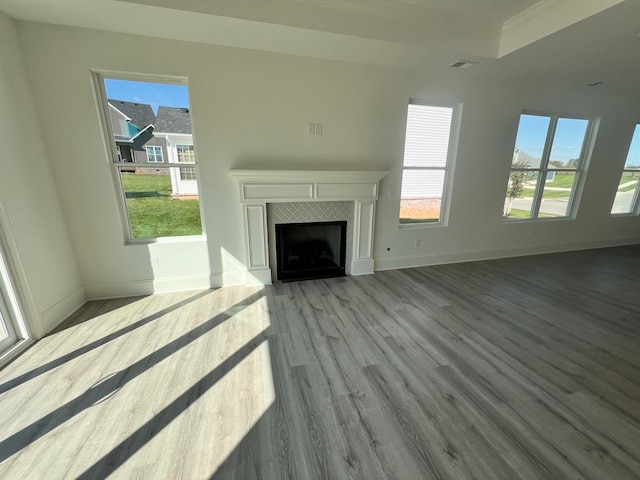 unfurnished living room with a healthy amount of sunlight and light hardwood / wood-style floors