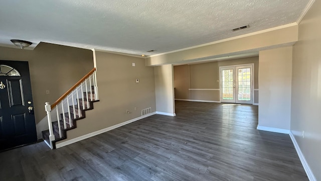 entrance foyer with crown molding, a textured ceiling, and dark wood-type flooring