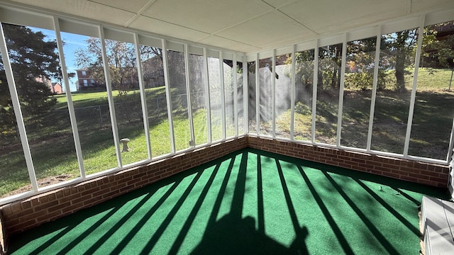 unfurnished sunroom featuring a drop ceiling