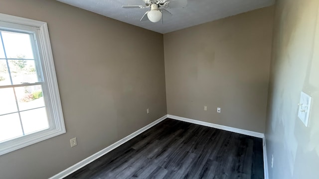 empty room with dark wood-type flooring and ceiling fan