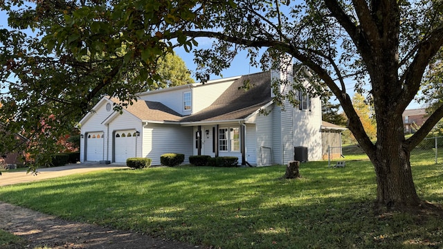 view of front facade featuring a front yard, a garage, and cooling unit