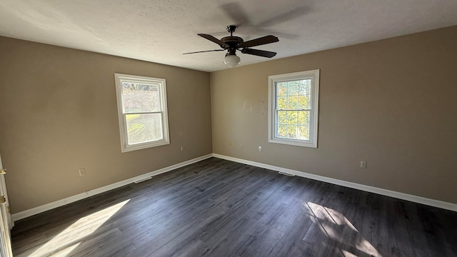 unfurnished room with dark hardwood / wood-style floors, a textured ceiling, and ceiling fan