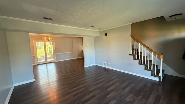 unfurnished room featuring an inviting chandelier, crown molding, a textured ceiling, and dark hardwood / wood-style flooring