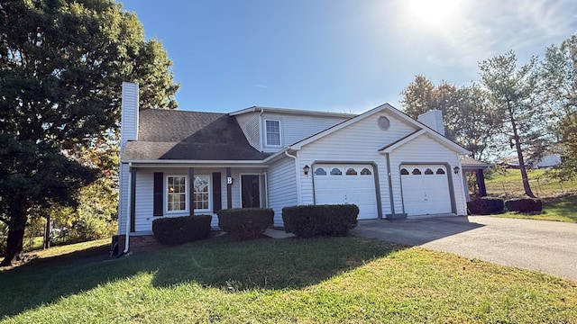 view of front of house with a front yard and a garage