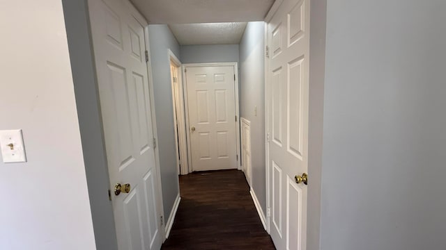 hallway with dark wood-type flooring