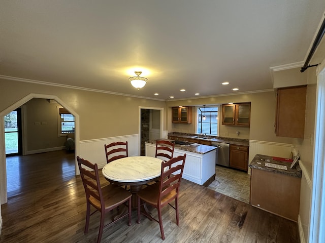 dining room with sink, ornamental molding, and dark wood-type flooring