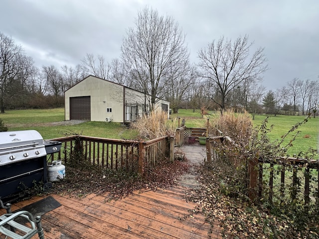 wooden deck featuring an outbuilding, area for grilling, a garage, and a lawn