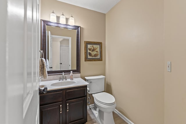 bathroom with toilet and vanity