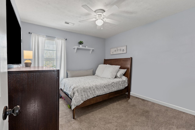 bedroom with light carpet, a textured ceiling, and ceiling fan