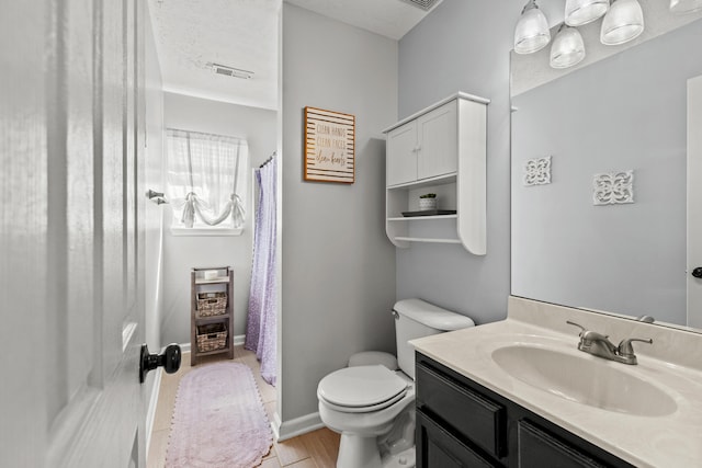 bathroom featuring toilet, a textured ceiling, vanity, and wood-type flooring