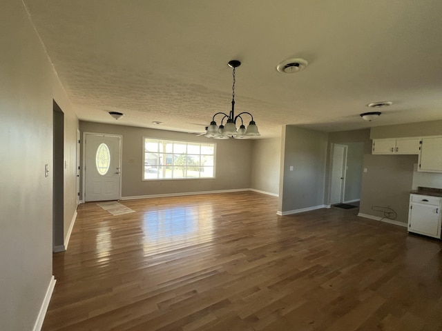 interior space with hardwood / wood-style floors and an inviting chandelier