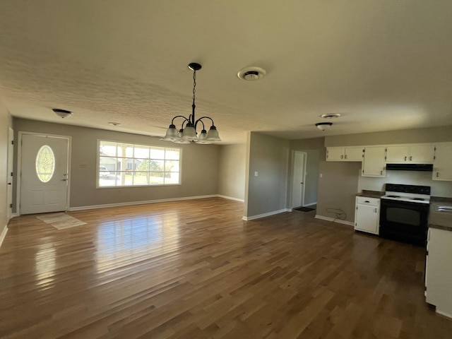 kitchen with an inviting chandelier, white cabinets, white electric stove, dark hardwood / wood-style floors, and decorative light fixtures