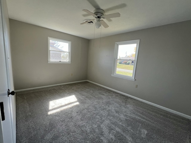 carpeted spare room with ceiling fan and a healthy amount of sunlight