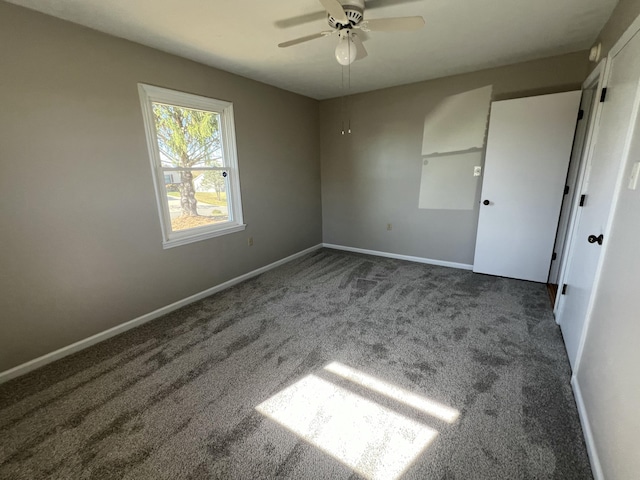 carpeted spare room featuring ceiling fan