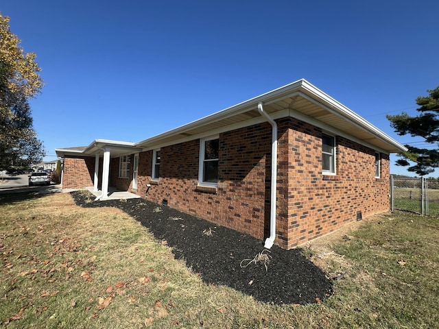 view of property exterior with a yard