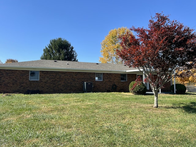 view of property exterior with a lawn and cooling unit