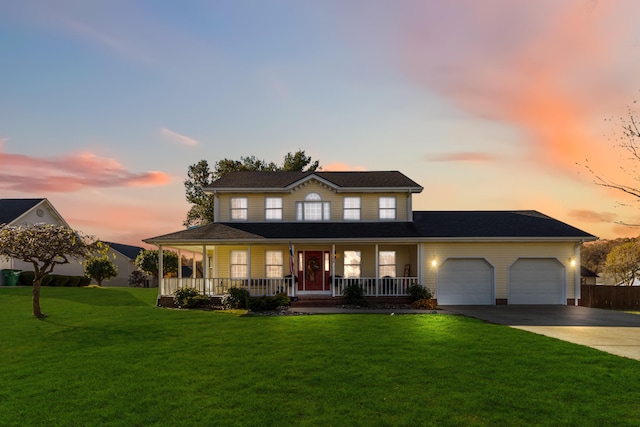 view of front of property featuring a porch, a garage, and a lawn