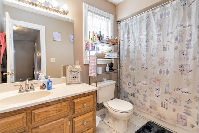 bathroom with vanity, toilet, and tile patterned floors