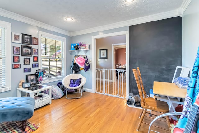 office area with crown molding, hardwood / wood-style floors, and a textured ceiling