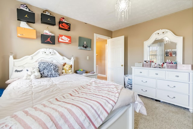 carpeted bedroom with a notable chandelier