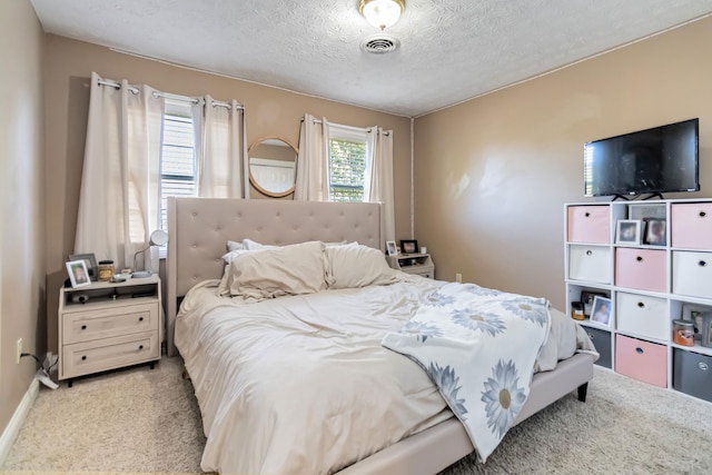 carpeted bedroom with a textured ceiling