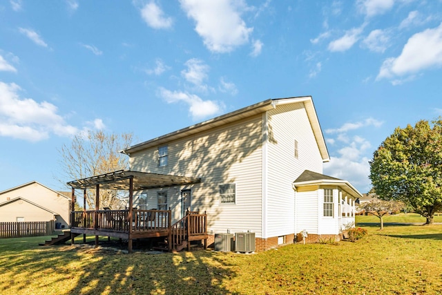 back of property with a wooden deck, a lawn, and a pergola